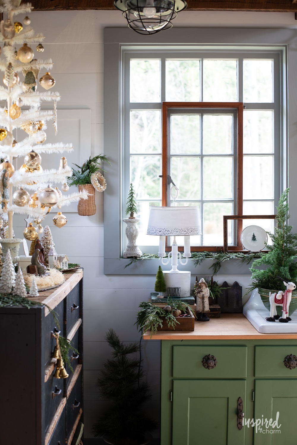 vintage windows and feather tree with green cabinet.
