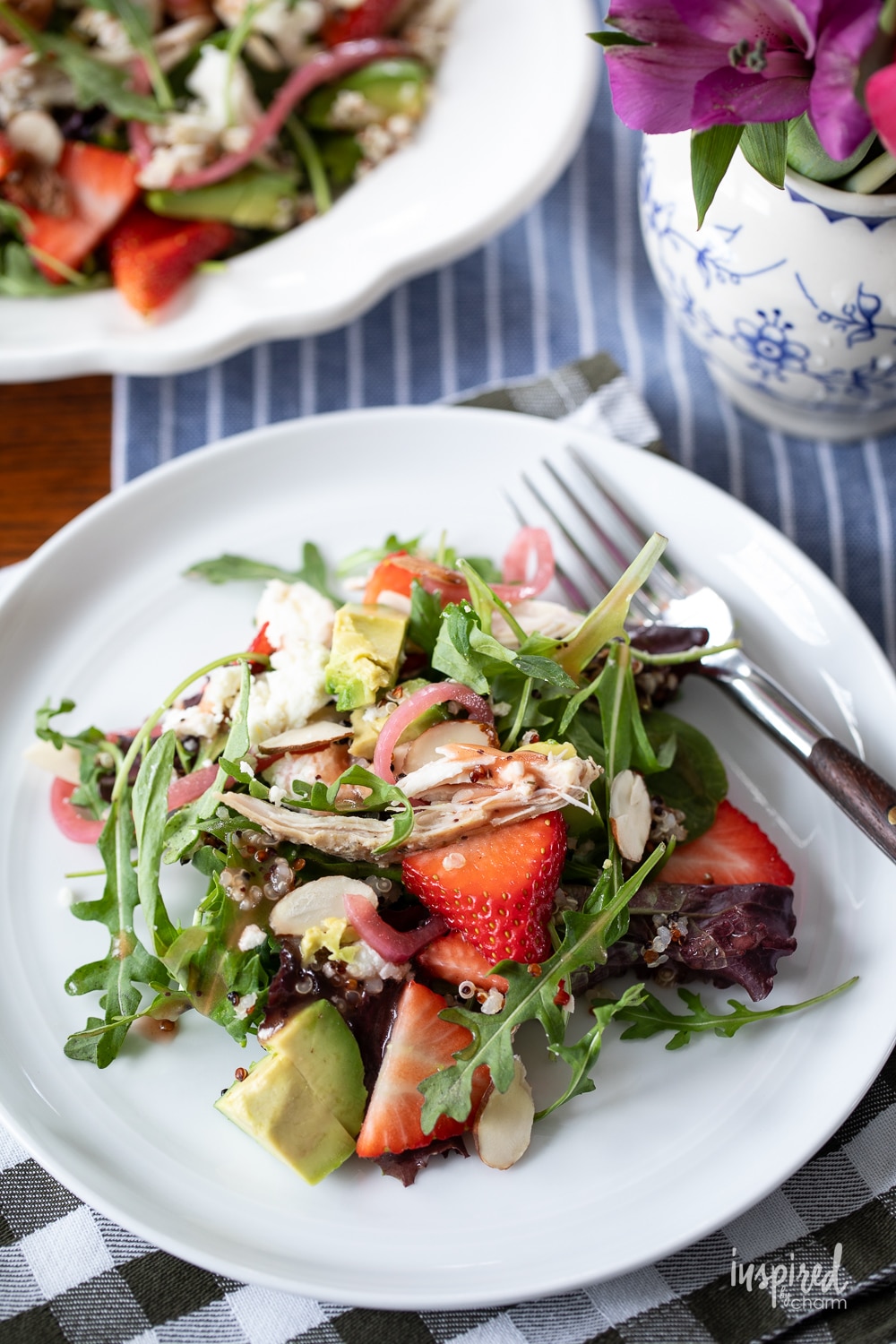 Chicken Quinoa Strawberry Salad on a plate with a fork.