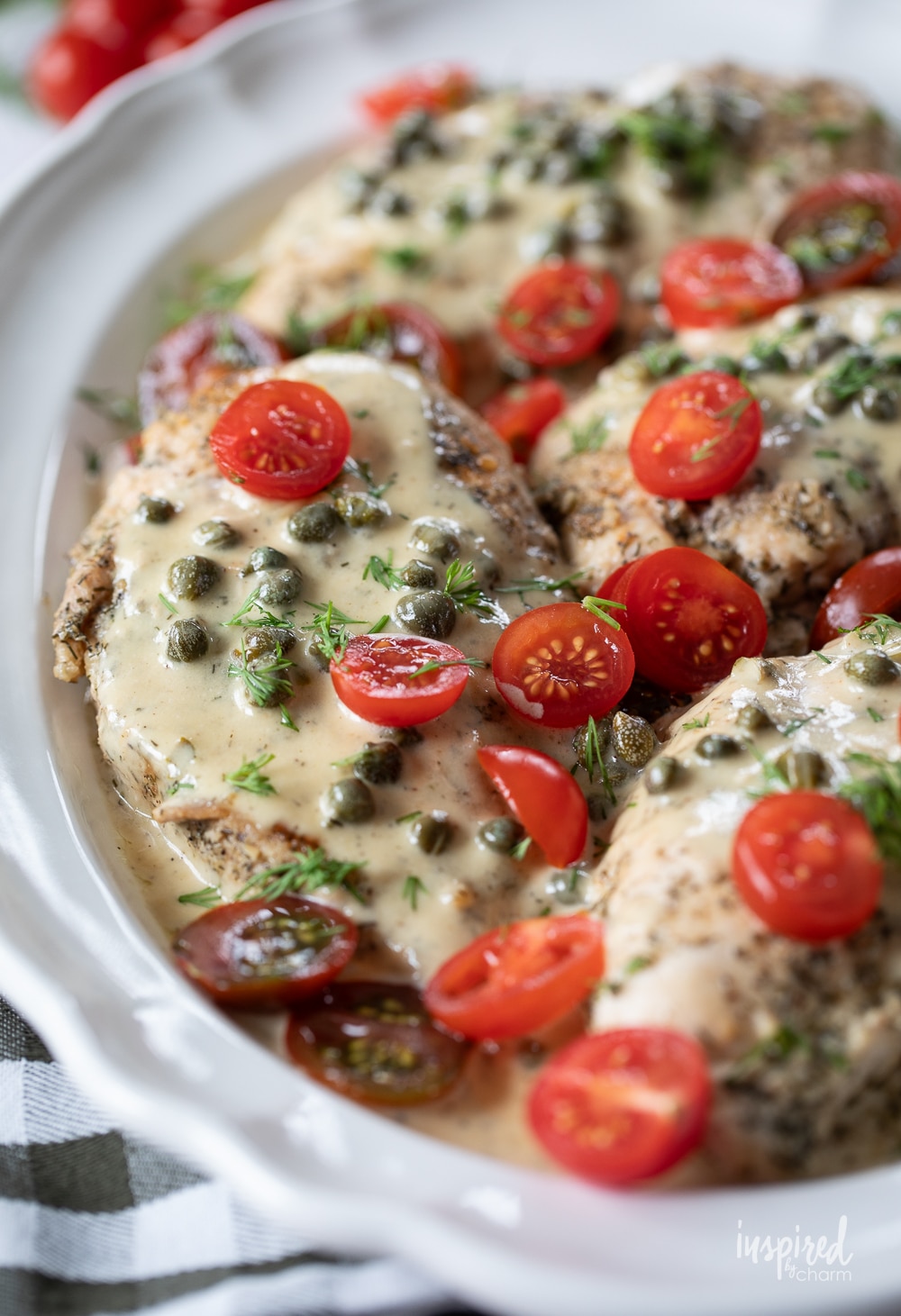 chicken served in a caper cream sauce with tomatoes.