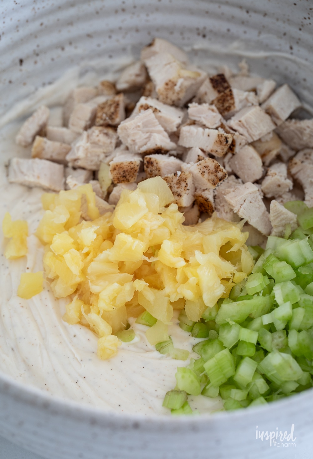 ingredients for chicken salad unmixed and in a bowl.