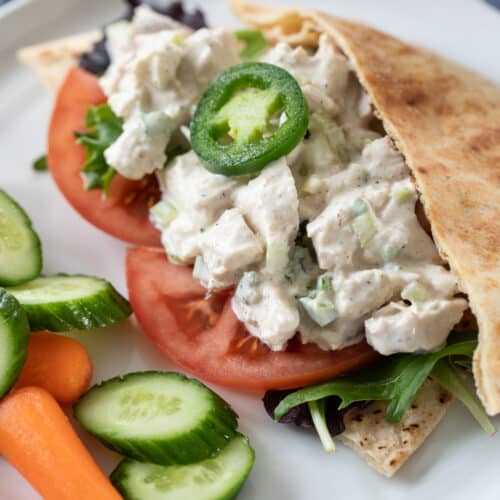 Jalapeño Honey Chicken Salad served in a pita with vegetables.