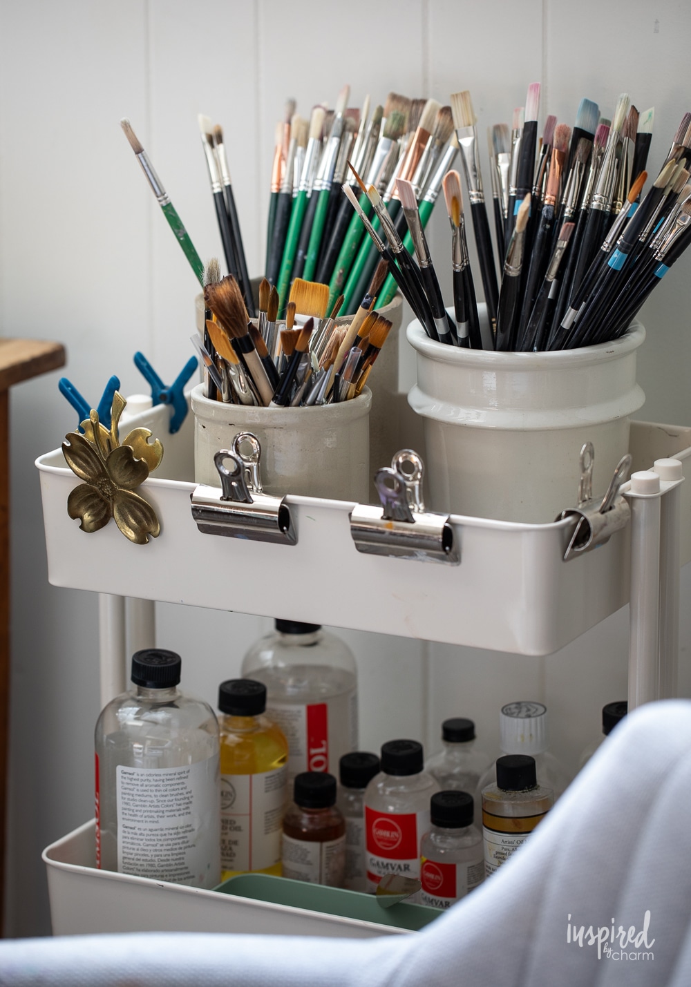 cart filled with oil painting brushes.