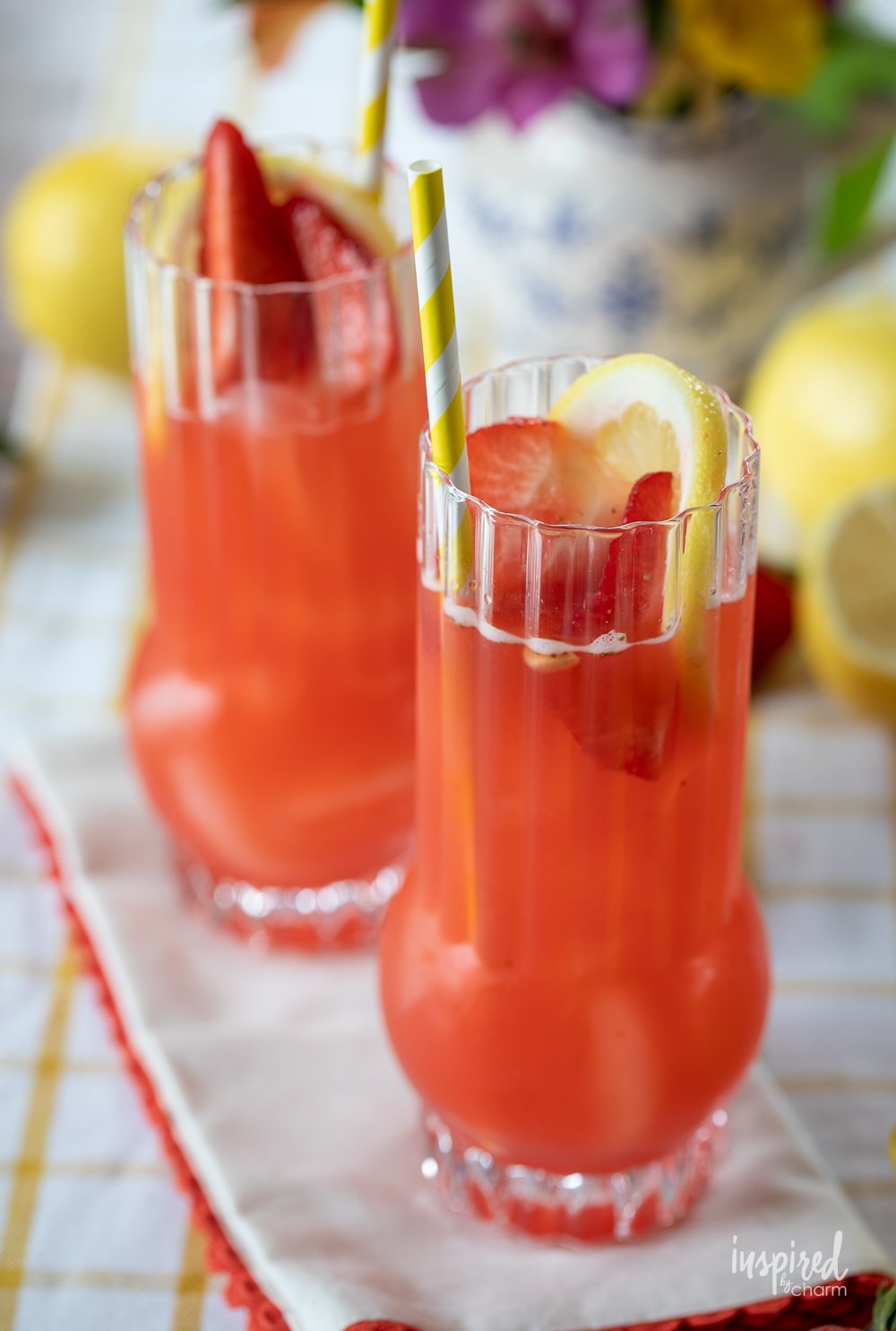 two Strawberry Lemonade Vodka Cocktails in glasses on a table.