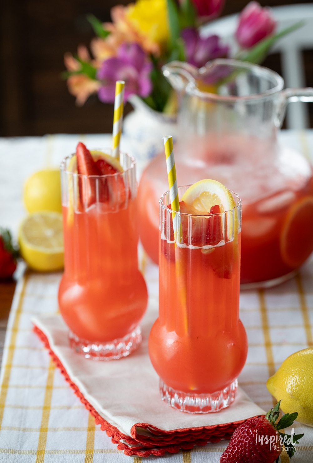 Strawberry Lemonade Vodka Cocktails in glass with a pitcher. 