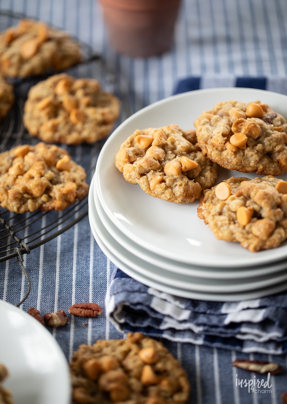 Butterscotch Chip Oatmeal Cookies on a plate and table with cooling rack.