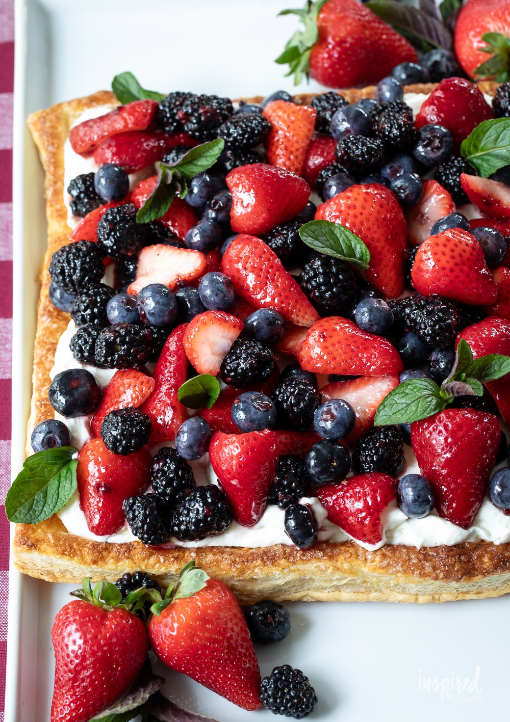 fruit pizza loaded with mixed berries and garnished with mint.