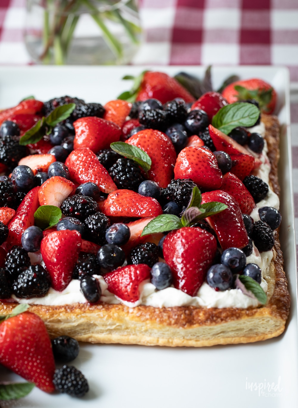 large mixed berry fruit pizza loaded with berries on a platter.