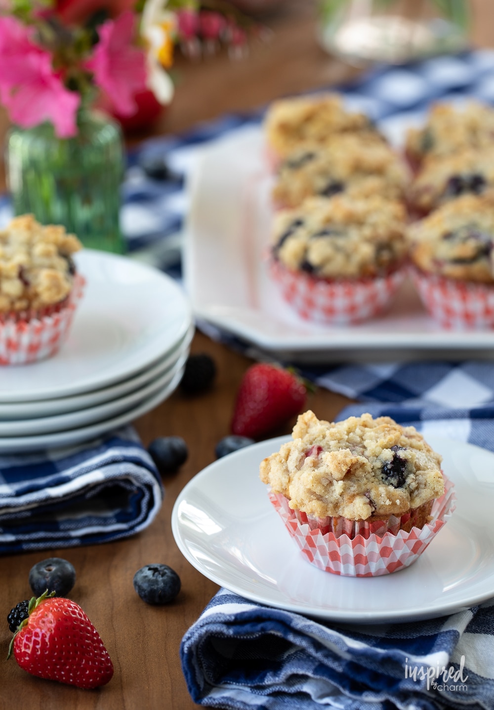 Triple Berry Muffins served on plates and a white platter.