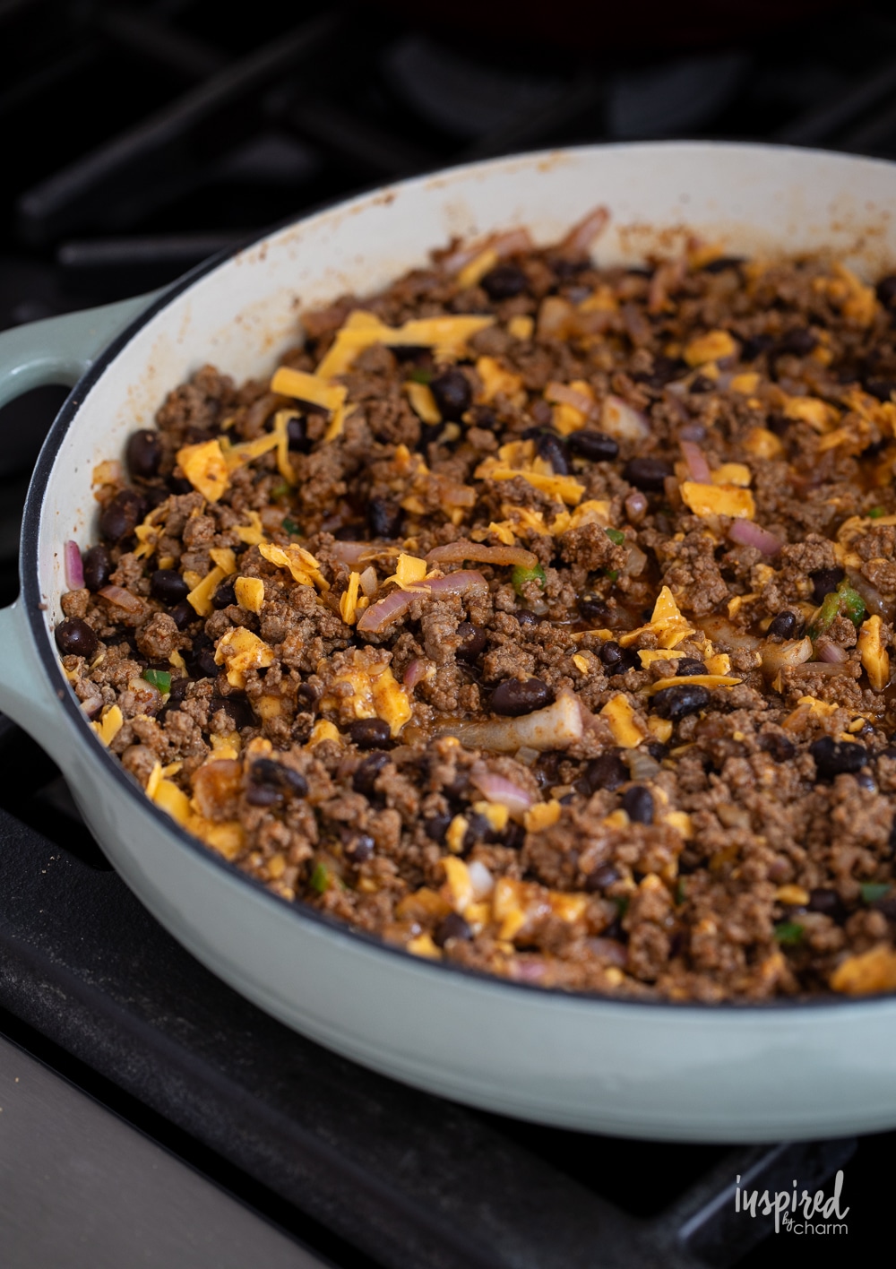 ground beef mixed with onions, beans, and cheese.