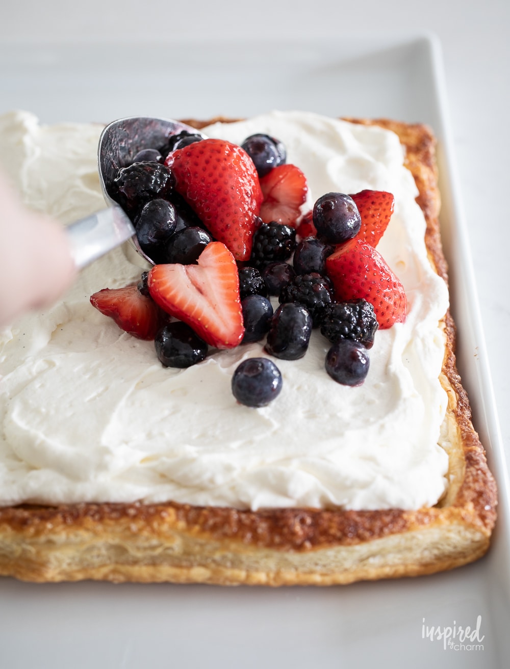 cream and fresh berries on puff pastry for fruit pizza.