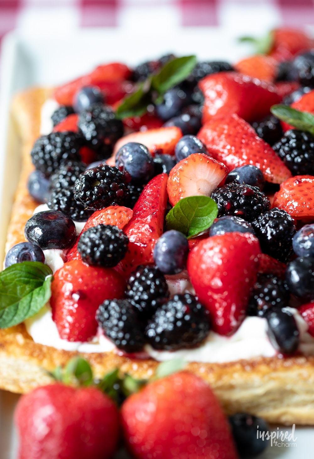 fruit pizza loaded with fresh berries and garnish with mint leaves.