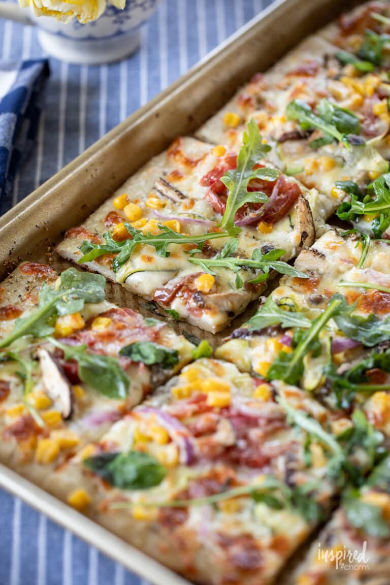 sheet pan pizza topped with a variety of vegetables.