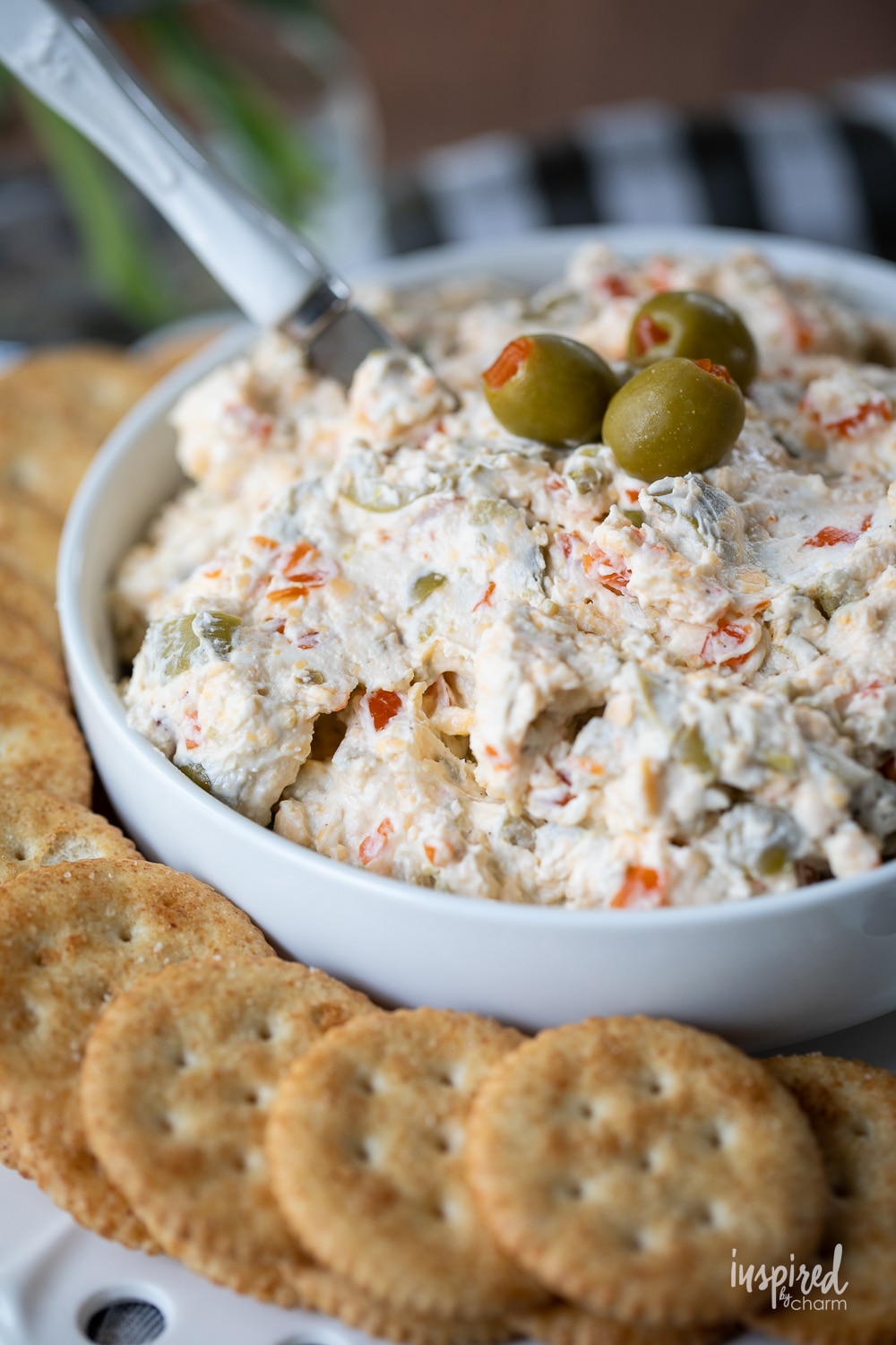 the best olive dip in a bowl garnished with olives.