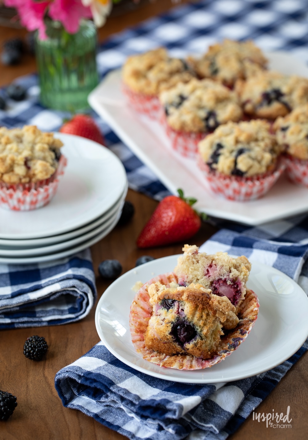 Triple Berry Muffins on a white platter served on smaller plates.