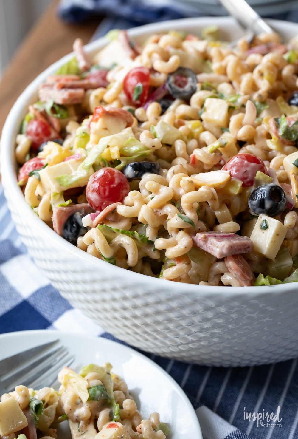 Italian Sub Pasta Salad in a bowl with portions served on a plate. 
