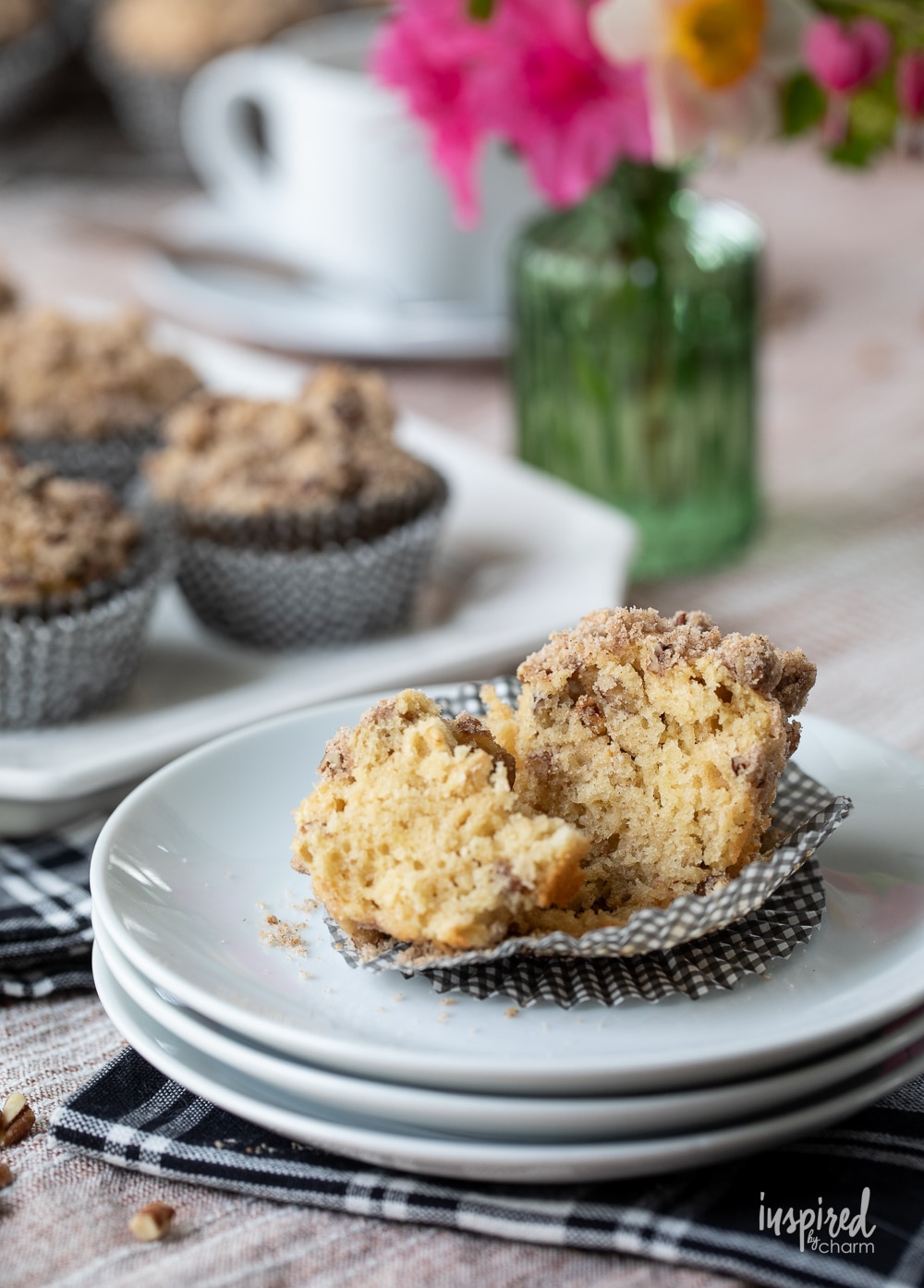 cinnamon maple morning muffins served on a platter with a single muffin cut in half on a plate.