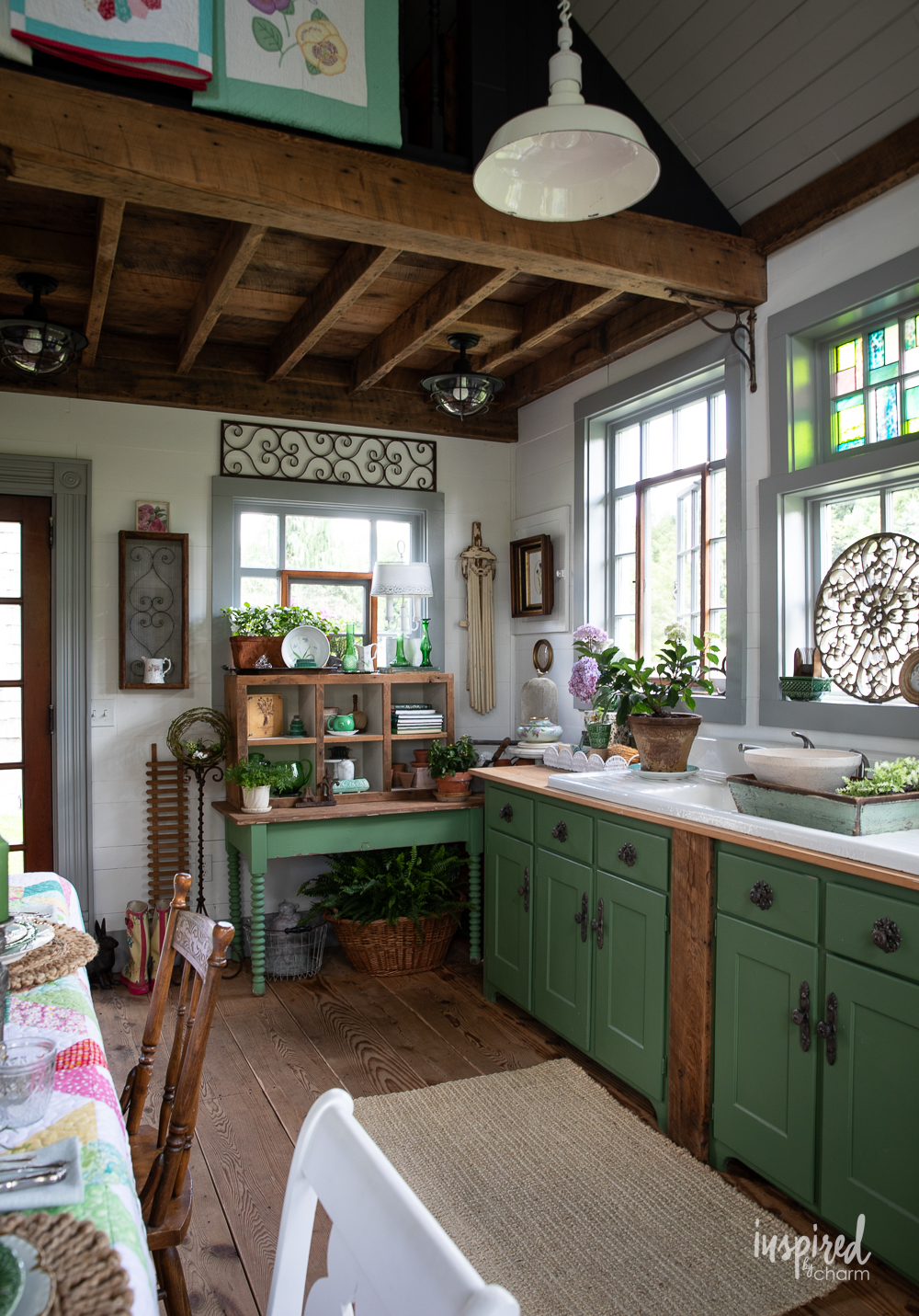 green cabinetry and table in a garden shed.