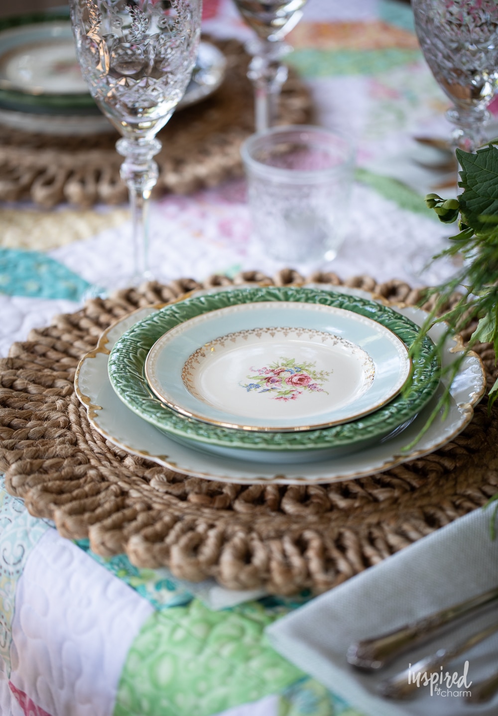 place setting with vintage plates and rattan chargers. 