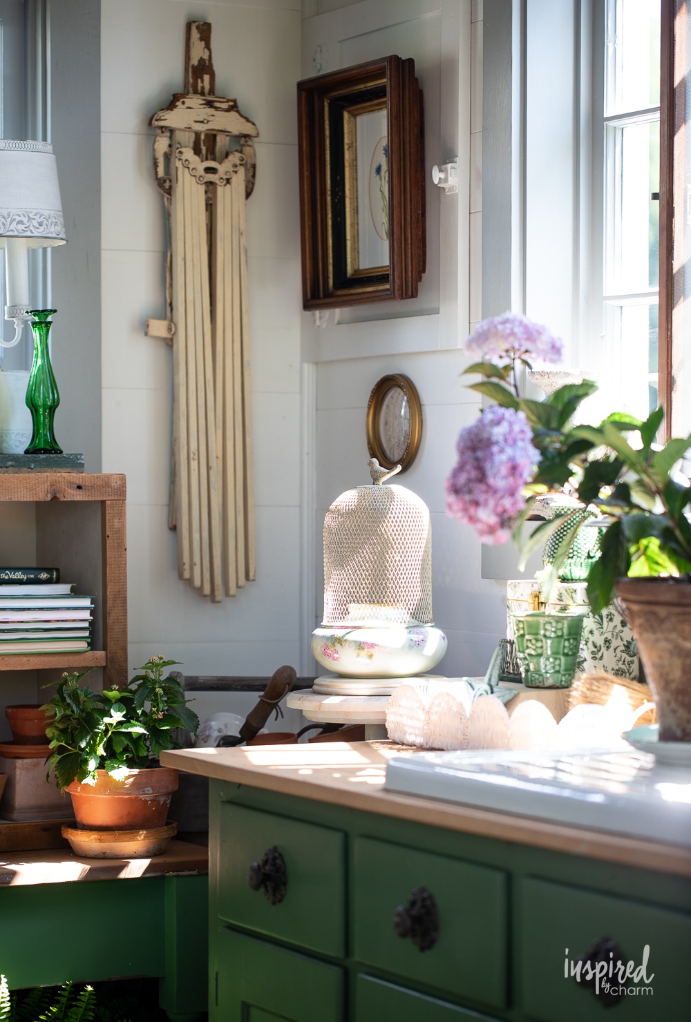 garden house with vintage decor and green cabinetry. 