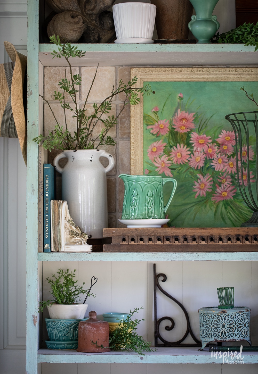 shelf with vintage decor, garden finds, and artwork.