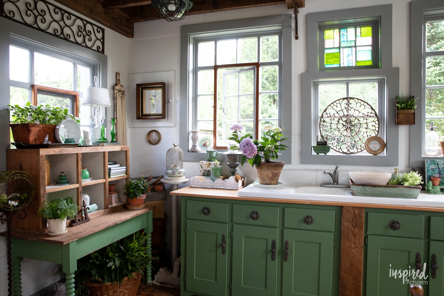 green cabinets with garden decor in potting shed.