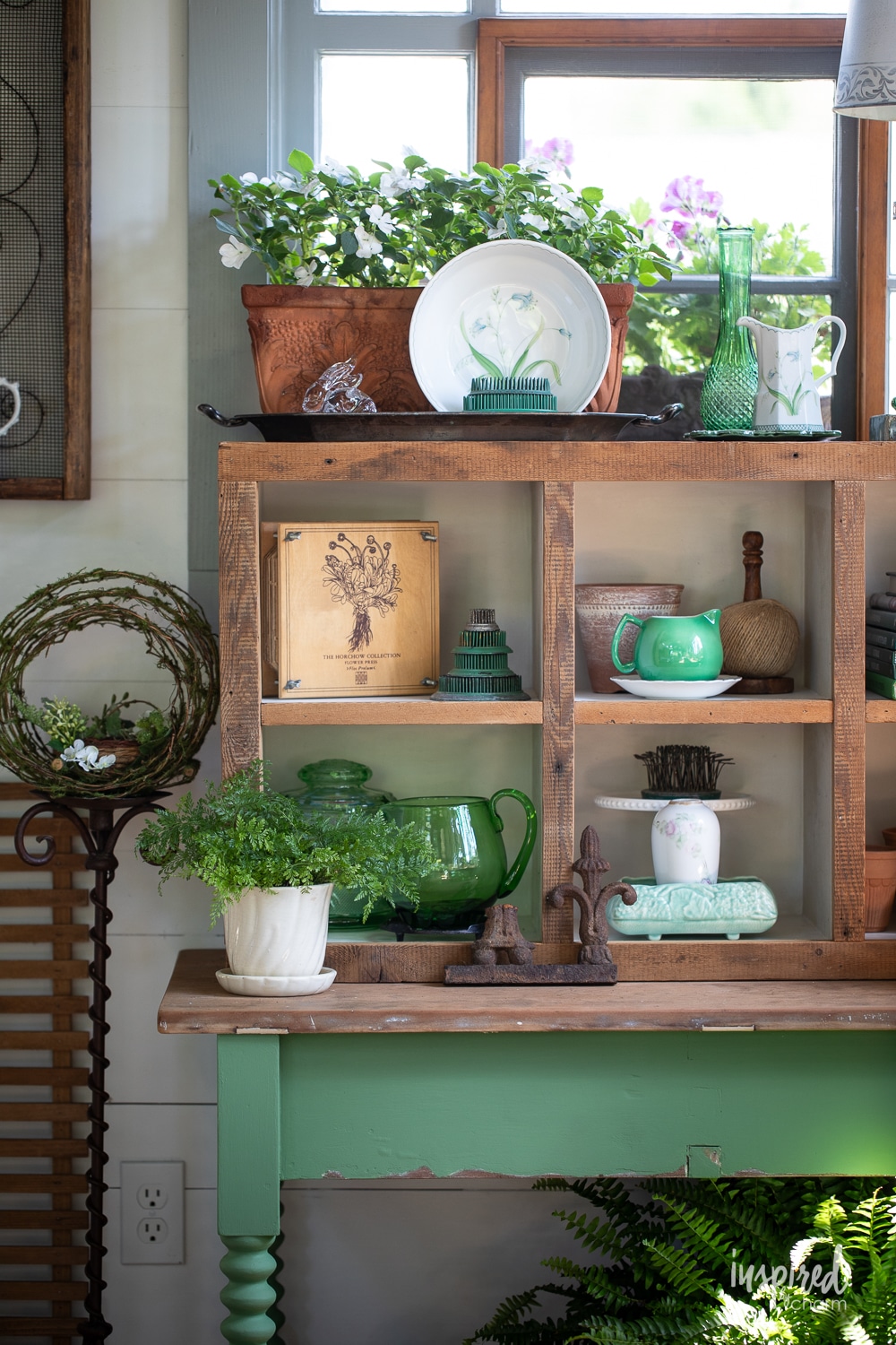 cubby holes filled with vintage and garden decor.