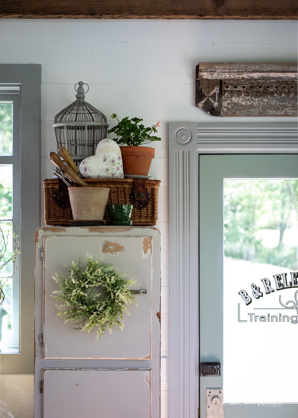 garden decor on top of a wood painted cabinet.