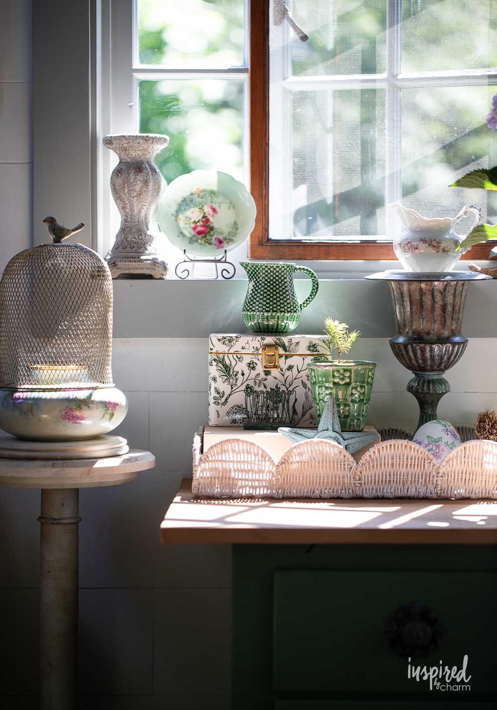 vignette in gardenhouse with vintage decor and plants.