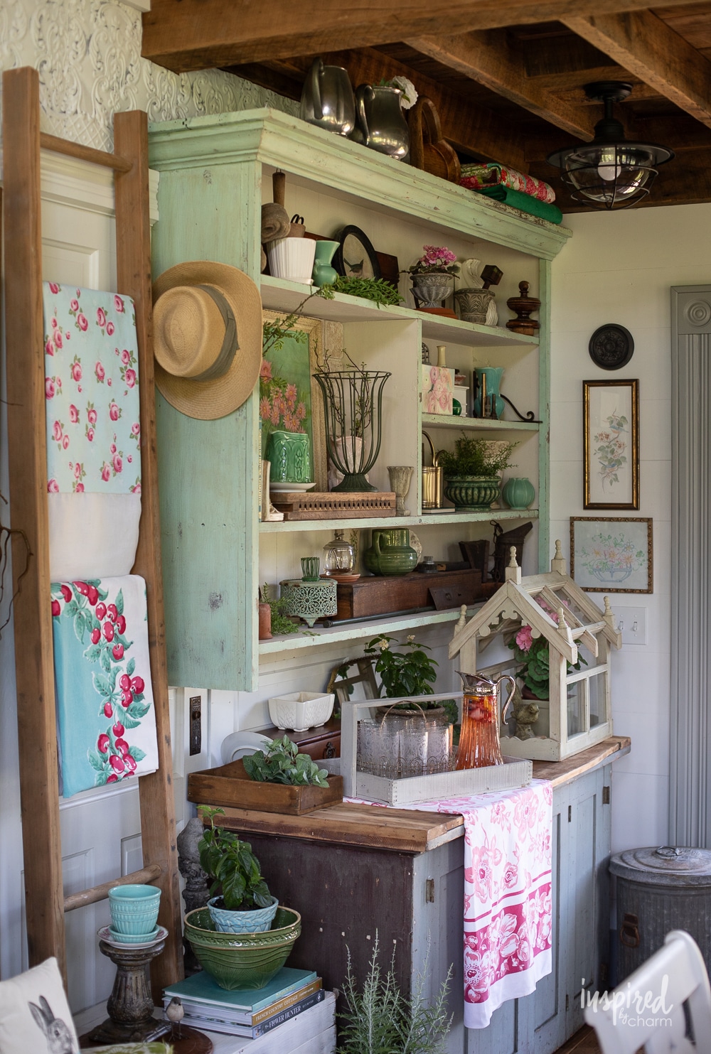 gardenhose with vintage shelf and decor with vintage linens.