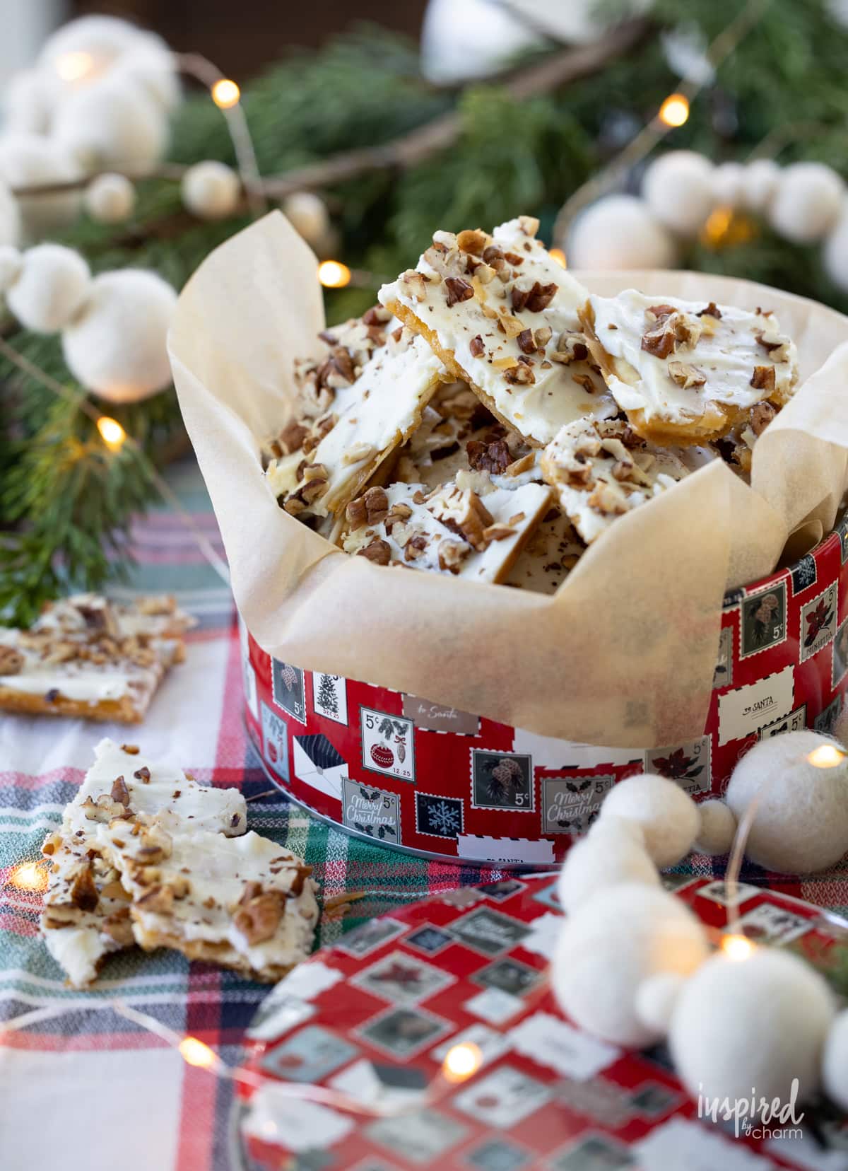 Salted White Chocolate Toffee with pecans on top on a festive table.