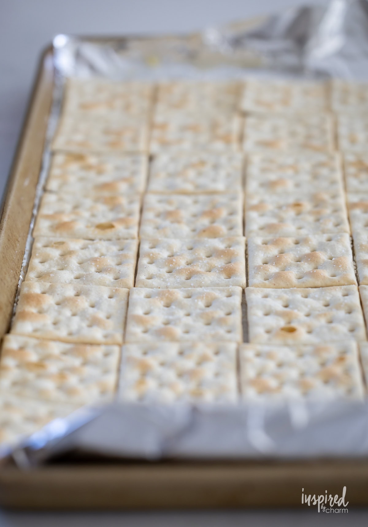 ritz crackers on foil line baking pan.