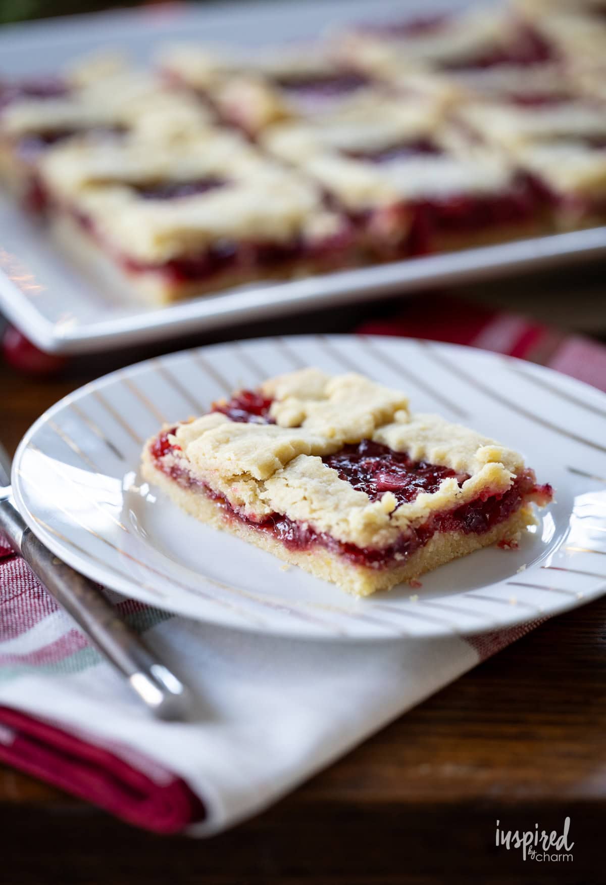 slice of apple cranberry bar on a plate with a fork.