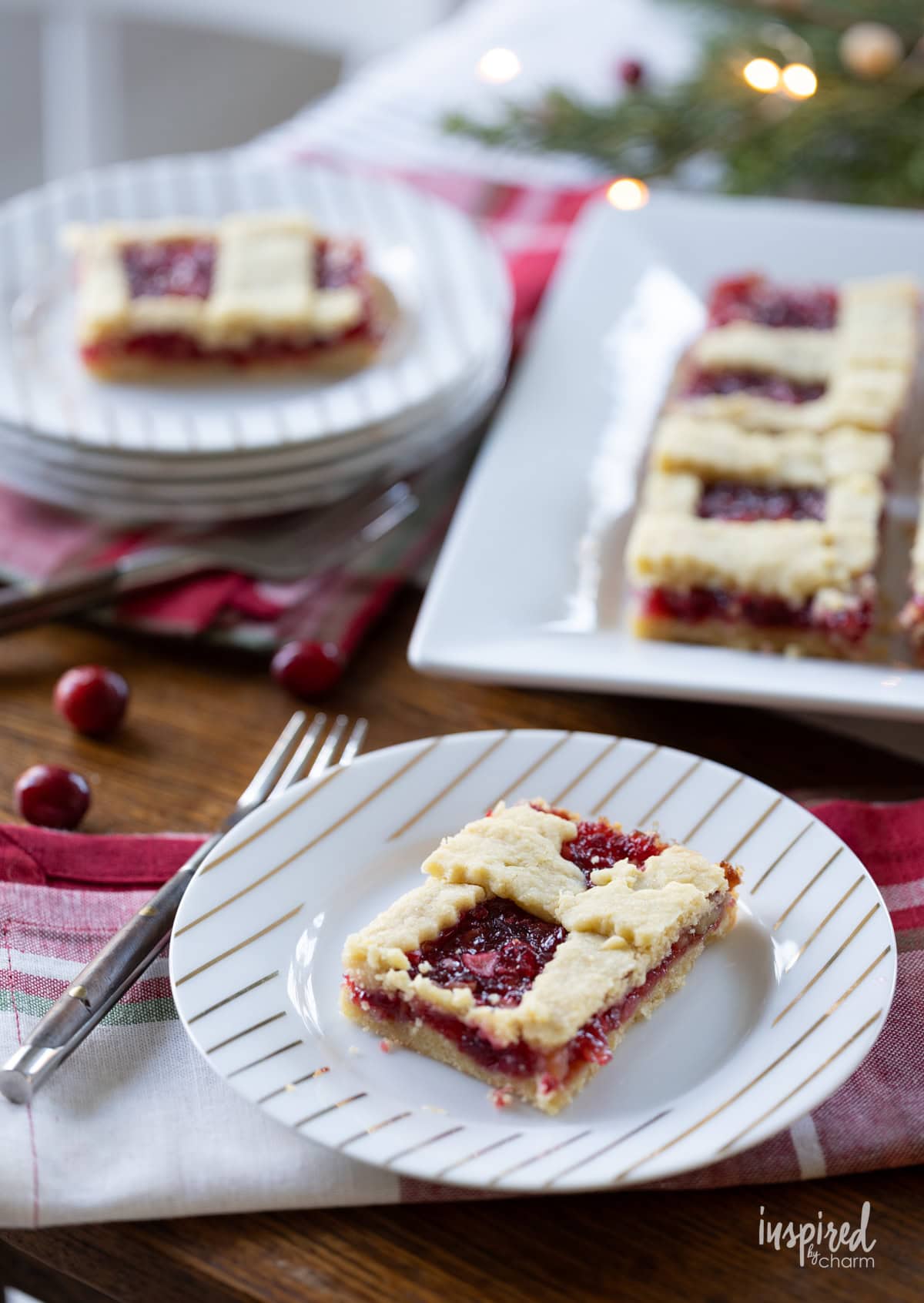 array of apple cranberry bars on plates and platters.