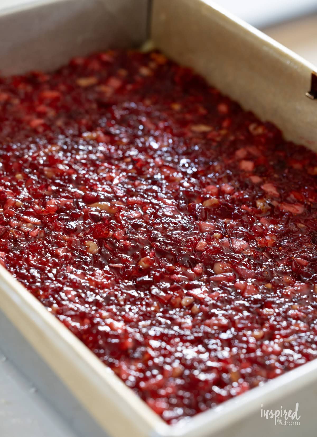 making apple cranberry bars in baking pan.