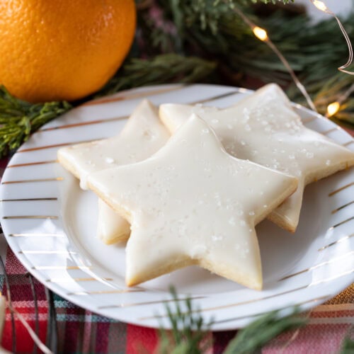 star shaped Orange Sugar Cookies on a plate.