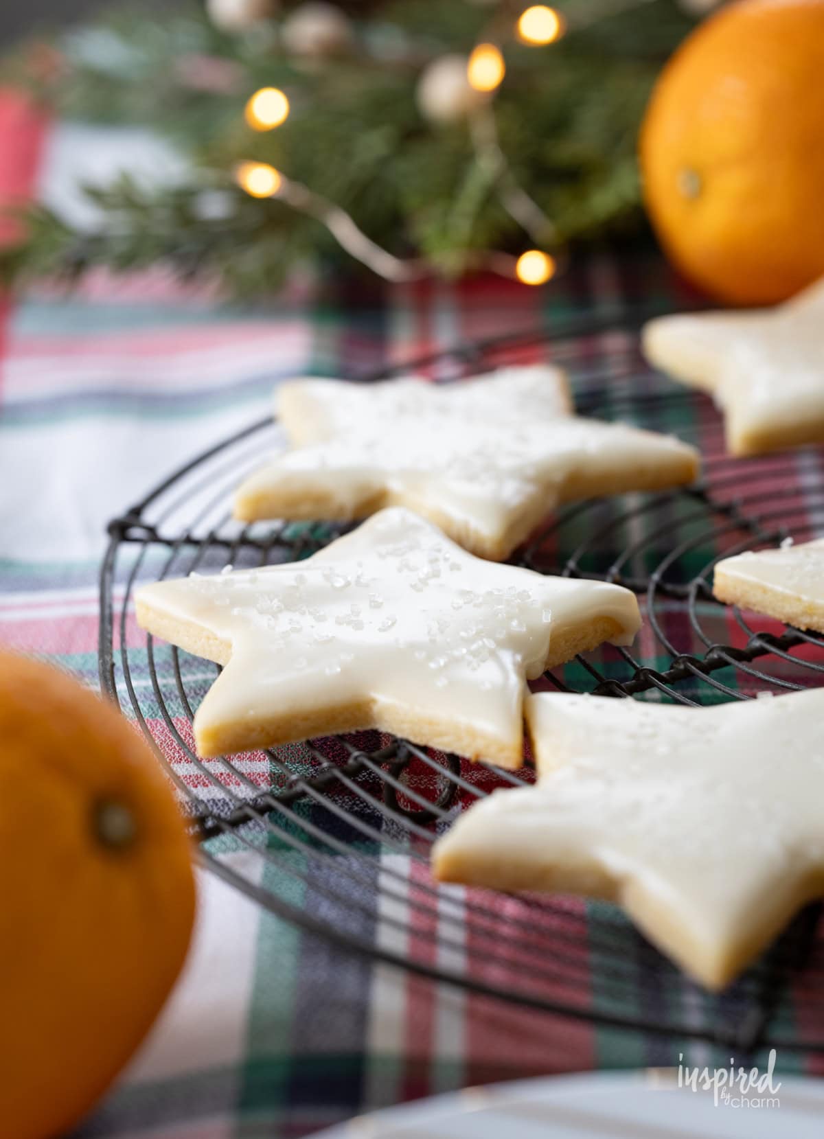 orange sugar cookies in a star shape on a baking rack.