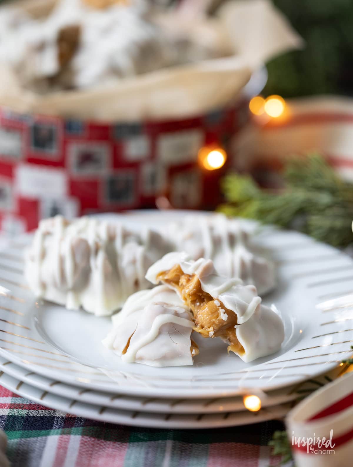 Homemade Caramel Cashew Clusters on a plate and in a tin.