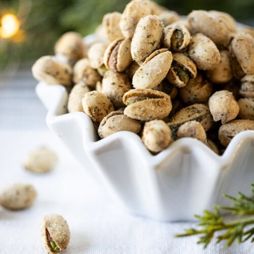 spicy ranch pistachios in a small fluted bowl.