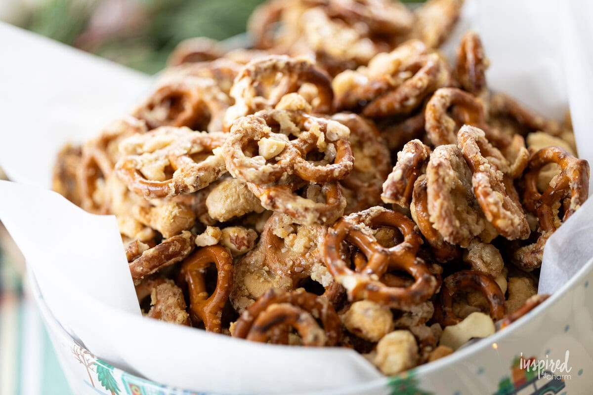 pile of Sweet & Salty Cashew Toffee Pretzels in a holiday tin.