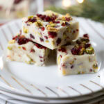 three pieces of Cranberry Pistachio Fudge on a plate.