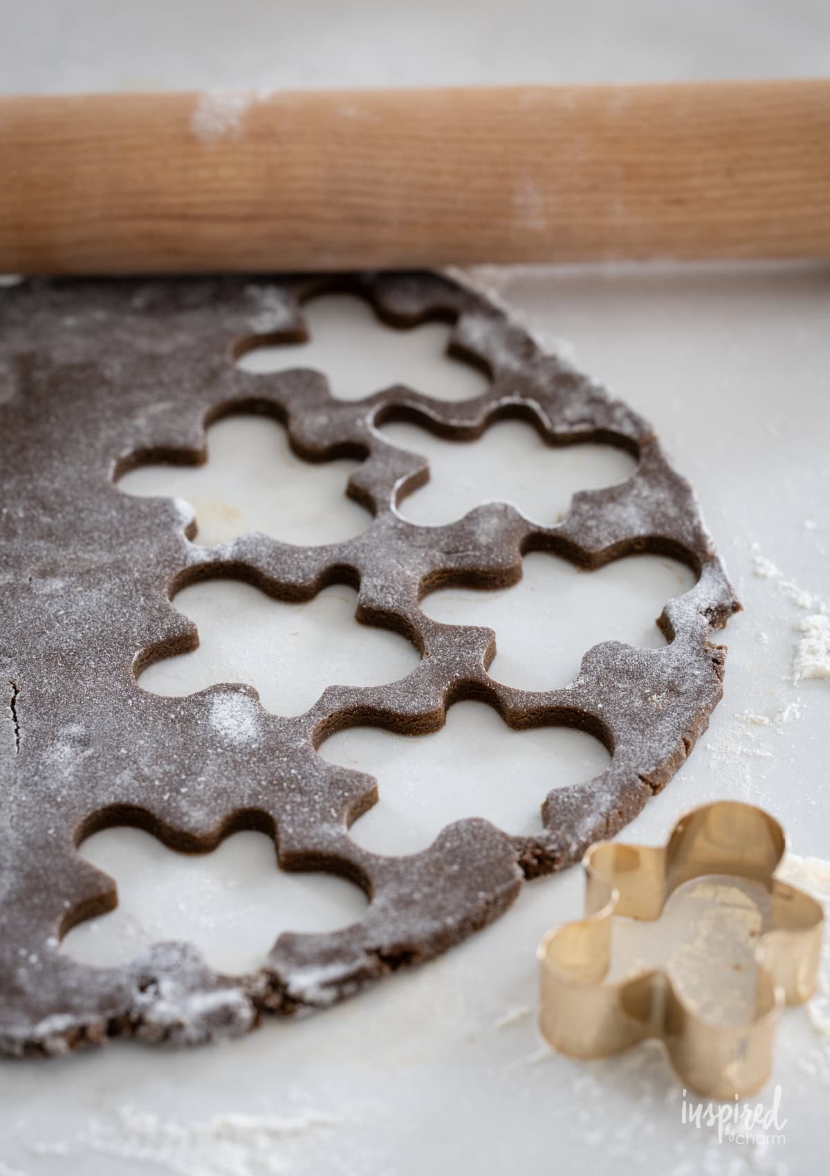gingerbread cookie dough rolled out and cut out with a cookie cutter.