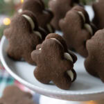 gingerbread sandwich cookies on a cake stand.