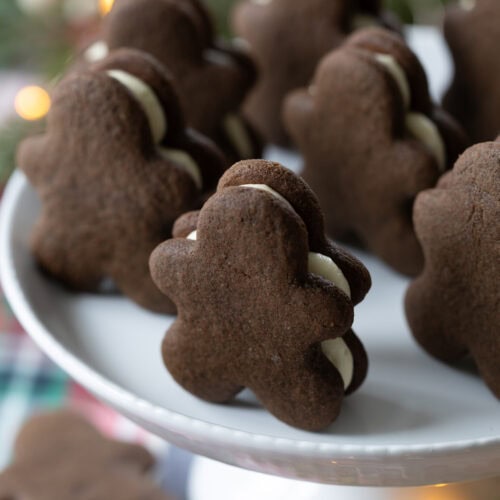 gingerbread sandwich cookies on a cake stand.