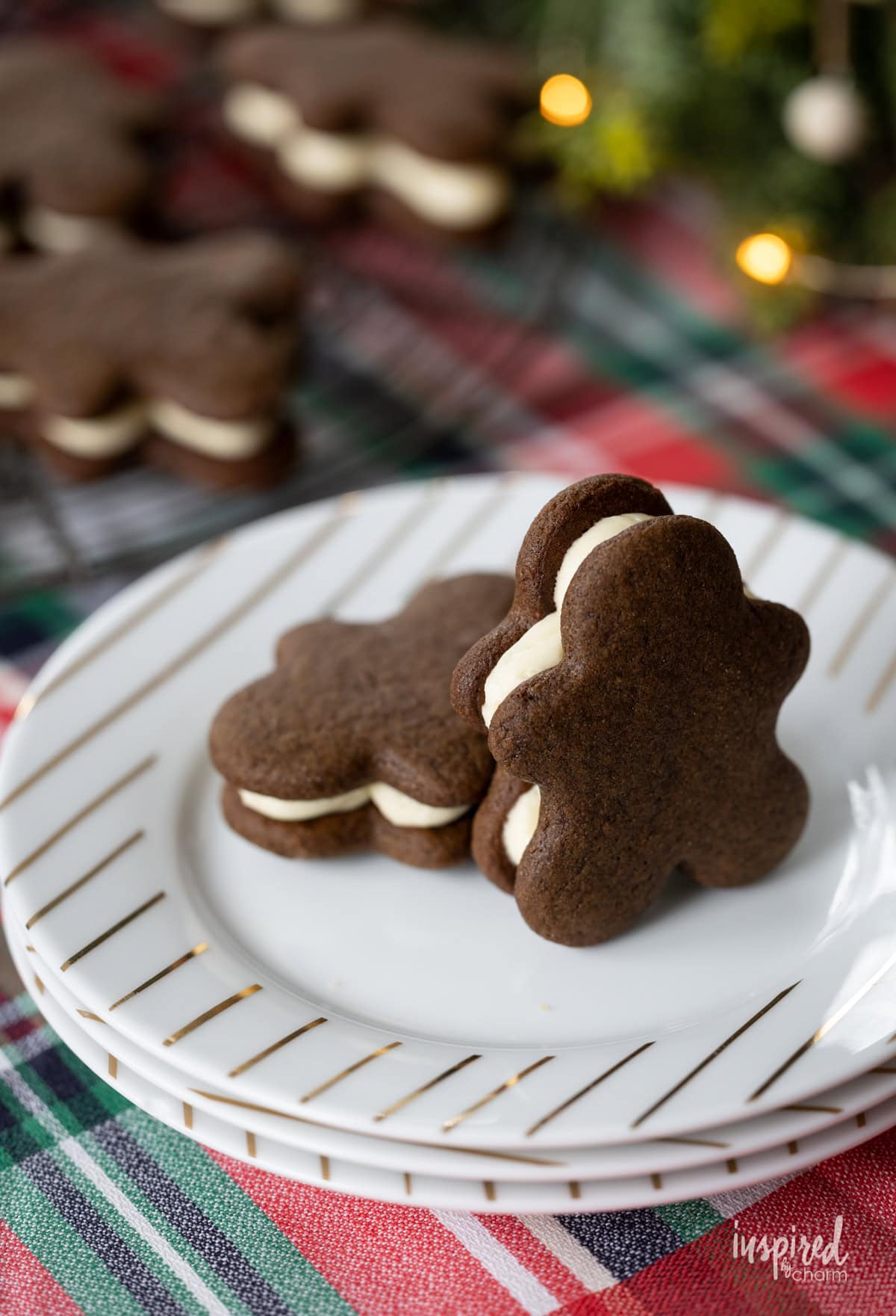 two gingerbread sandwich cookies on a plate.
