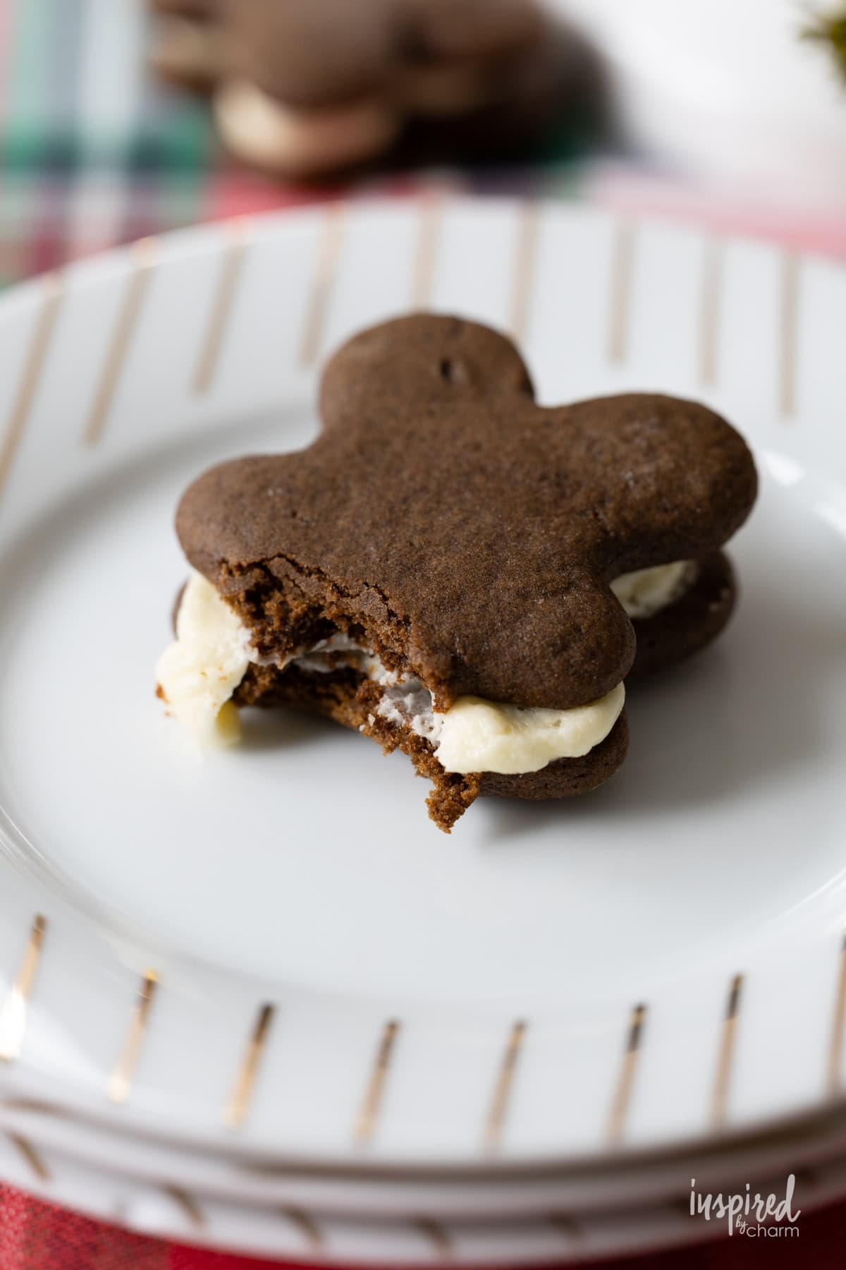 gingerbread sandwich cookie with a bite taken out.