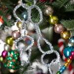 silver Pipe Cleaner Loop Garland hung on a festive christmas tree.