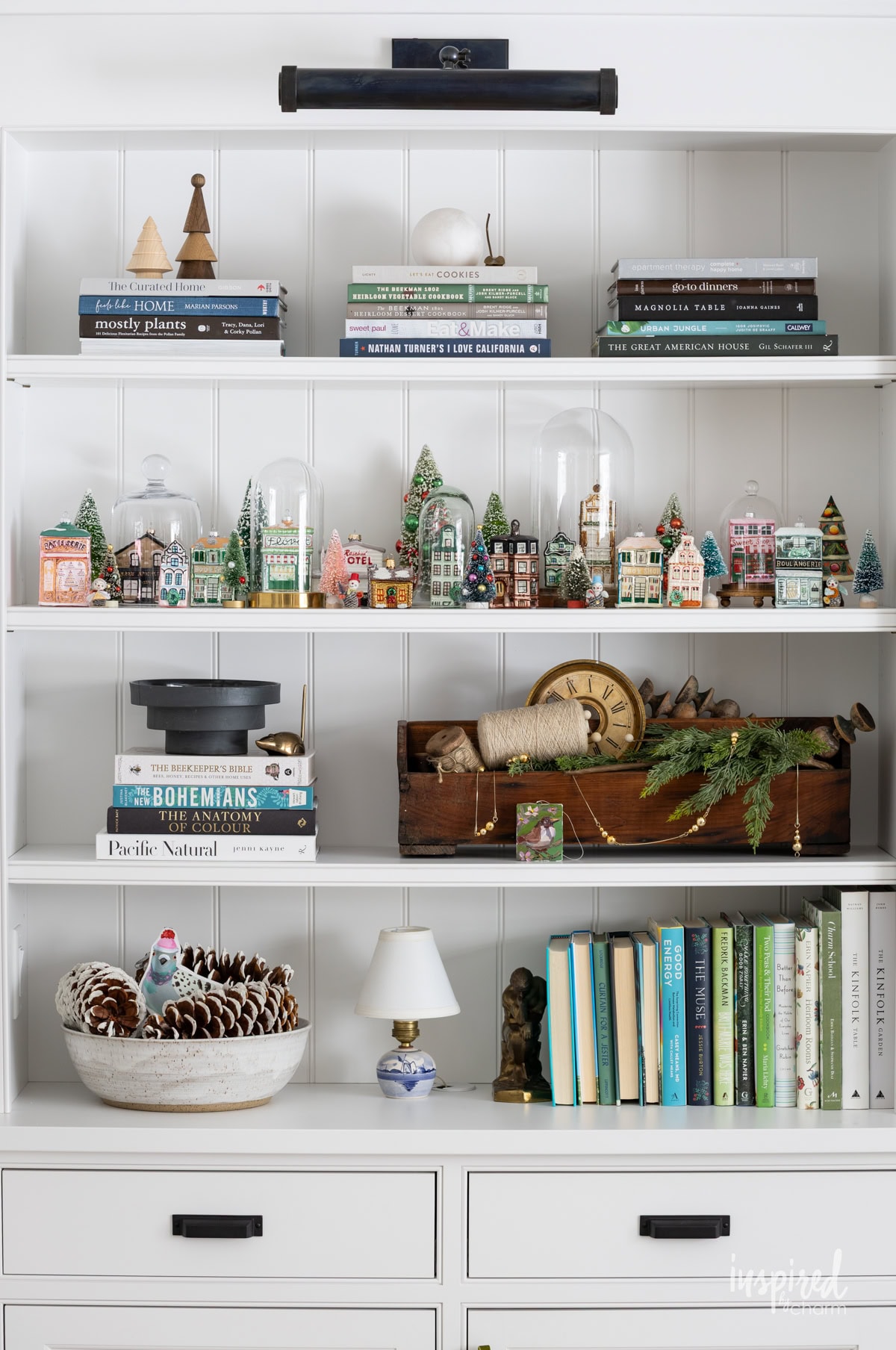 shelves decorating with Christmas decor and collection of glass house christmas ornaments. 