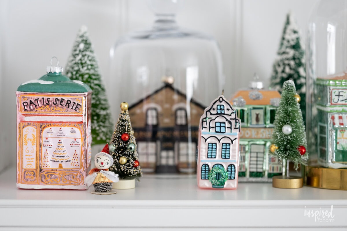 collection of glass house ornaments for Christmas.