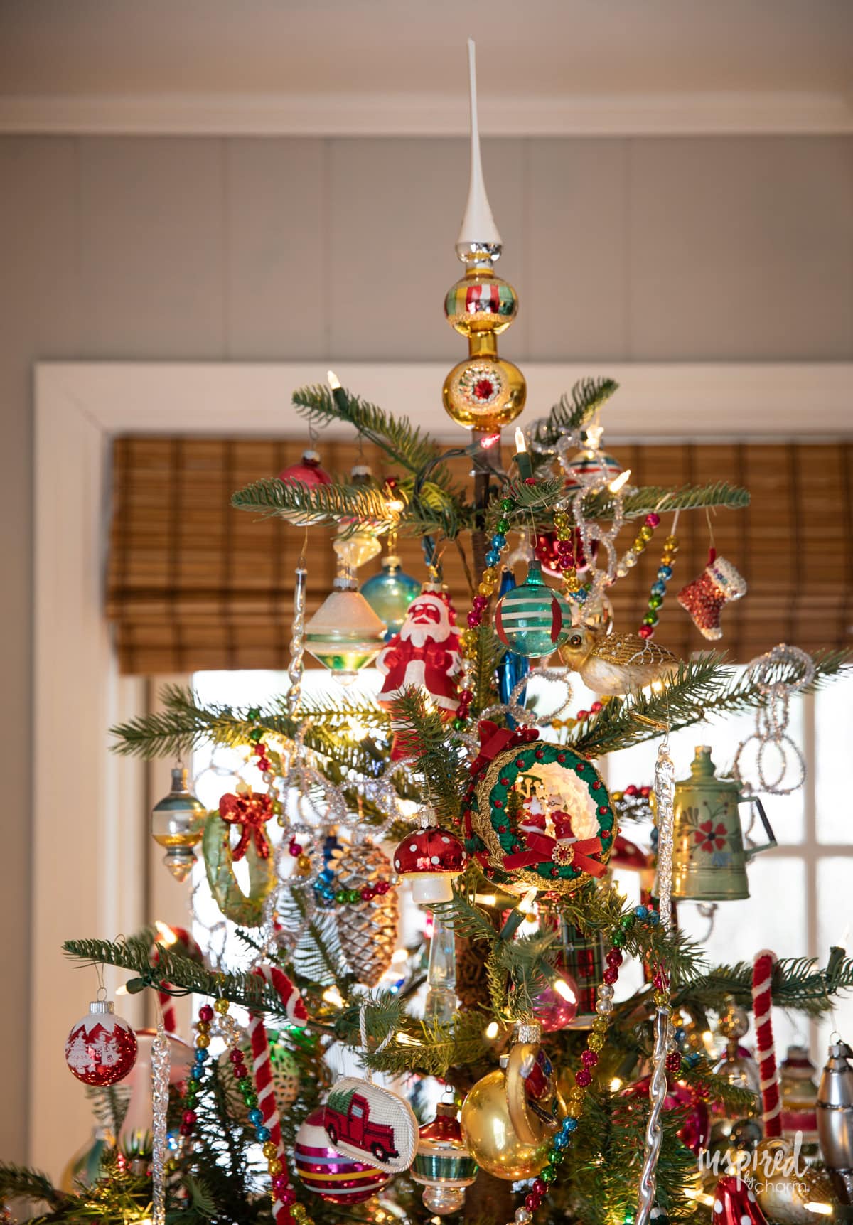 top of Christmas tree with vintage decor.