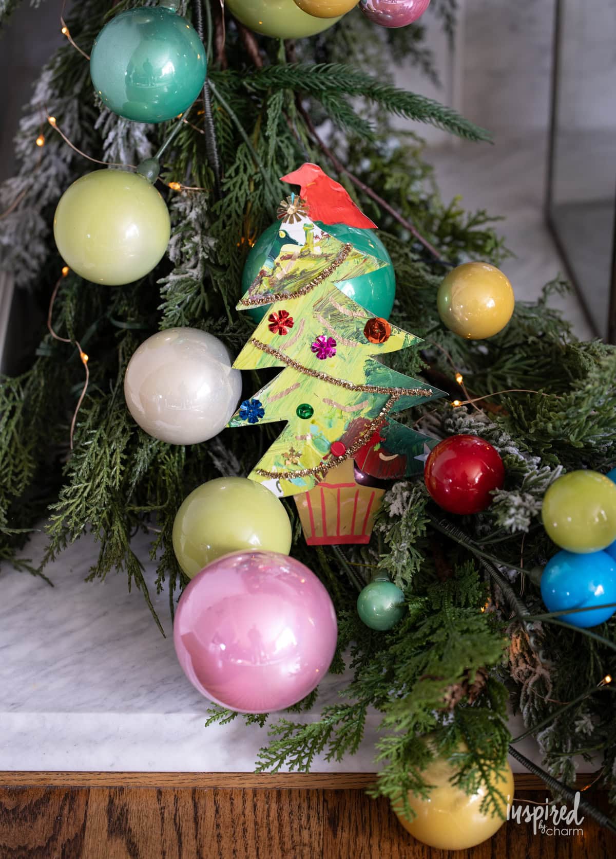 christmas tree made from painted papers in a festive garland.